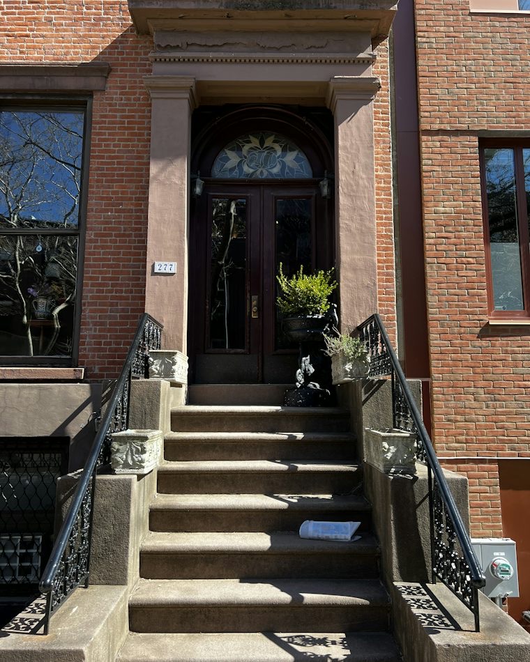 Brownstone stoop in Brooklyn with wrought-iron railings